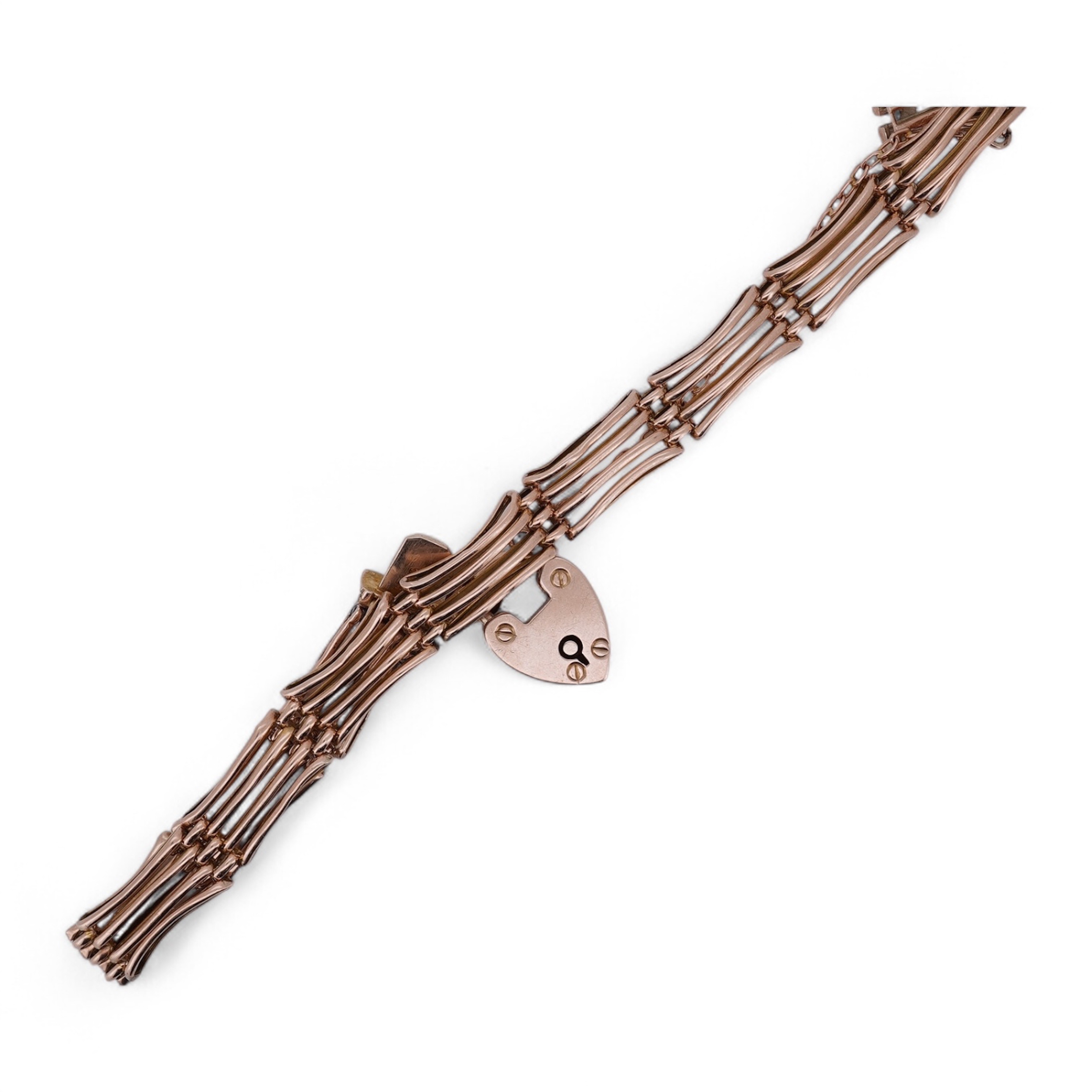 An early 20th century yellow metal gate link bracelet, with heart shaped padlock clasp on safety chain, stamped '9', approx. 18cm, 9.2 grams. Condition - poor